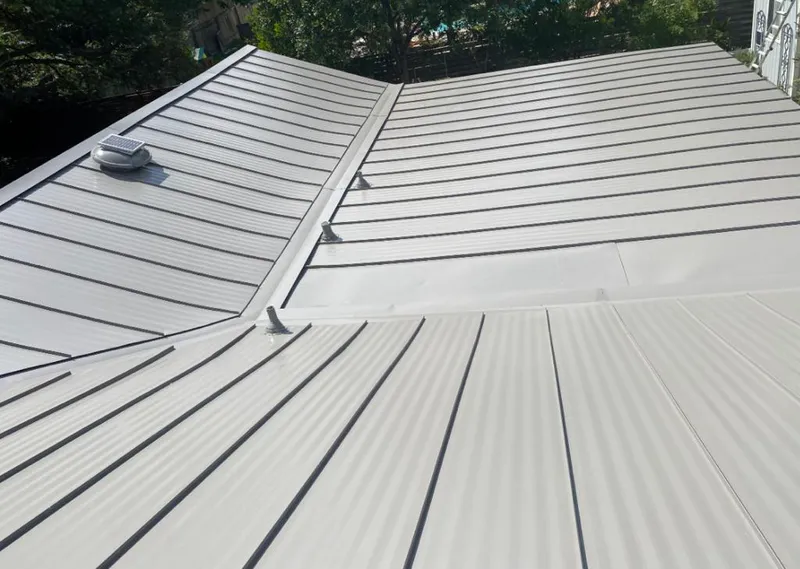Solar attic fan installed on a metal roof for Roof Ventilation in Epping